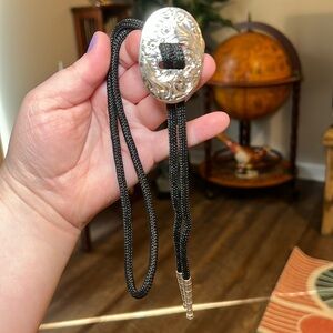 Vintage southwestern floral embossed silver metal black cord bolo tie necklace